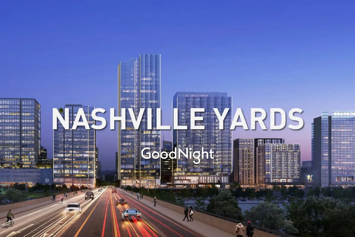 A dynamic cityscape showing modern skyscrapers, the Nashville skyline, and a busy road below, evoking the urban hustle and lively spirit of downtown Nashville. The view is vibrant and teeming with activity, reflecting the pulse of the city’s professional and cultural life.