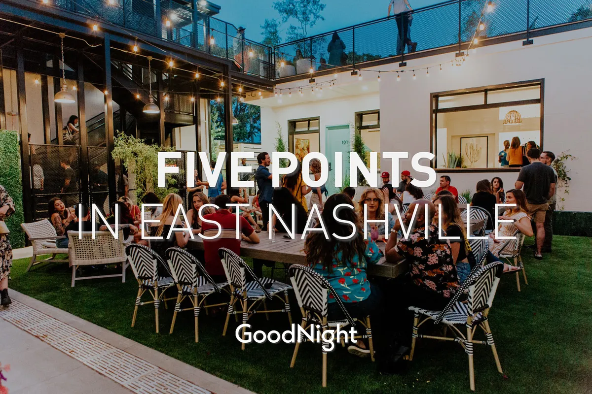 A lively outdoor scene with people gathered under decorative lighting, enjoying a festive atmosphere at an outdoor seating area. The group dynamic and celebratory mood embody the spirit of socializing and group gatherings.